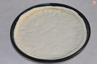 Homemade Shrimp and Chicken Pizza step 6: Transfer the dough to the pizza pan and prick the surface with a fork to prevent
