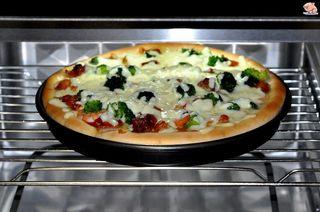Homemade Shrimp and Chicken Pizza step 9: Top with the remaining mozzarella cheese and let the pizza rest for 15 minutes.