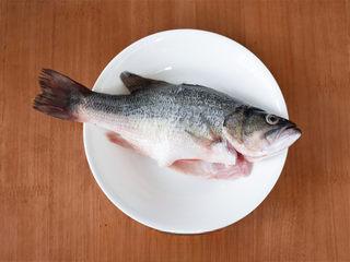Chinese Steamed Sea Bass step 1: Clean and prepare the sea bass, removing any scales and internal organs.