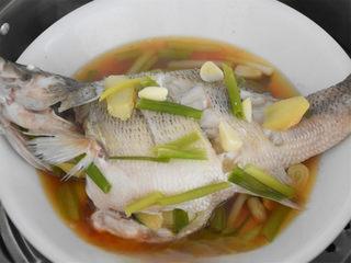Chinese Steamed Sea Bass step 7: Steam the fish over boiling water until fully cooked, adjusting the cooking time