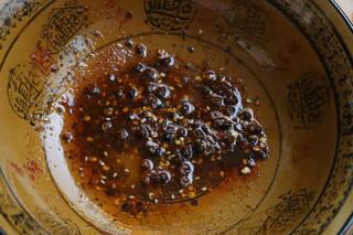 Spicy Black Fungus Salad step 5: Place the chili paste and Sichuan peppercorns in a large mixing bowl. Carefully