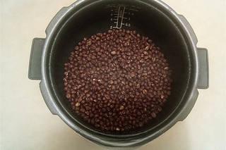 Steamed Red Bean Buns step 3: Transfer the cooked beans to a pan and cook over medium heat to remove excess mo