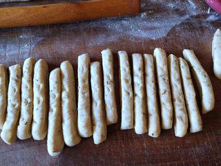 Cumin Fried Dough Sticks step 8: Arrange the strips on a tray, cover with plastic wrap, and let rise again for ab
