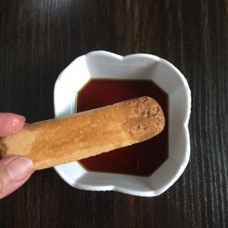 Classic Tiramisu Cake step 7: Quickly dip each ladyfinger into the coffee liqueur or coffee mixture, ensuring