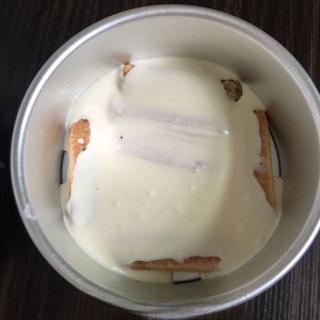 Classic Tiramisu Cake step 9: Spread half of the mascarpone cream mixture evenly over the ladyfingers.