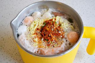 Cheesy Kimchi Ramen step 4: Stir in the kimchi and the seasoning packet from the ramen.