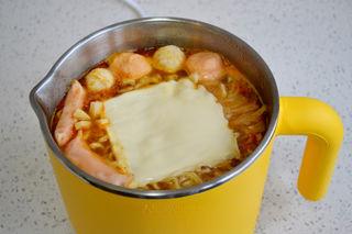 Cheesy Kimchi Ramen step 6: Place the mozzarella cheese slices on top and allow them to melt into the hot br