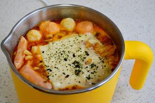 Cheesy Kimchi Ramen step 7: Simmer for 1 minute, then transfer to a serving bowl.