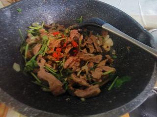 Cumin Lamb Stir-Fry with Cilantro step 13: Add the cumin powder and chili powder. Toss quickly for another 10–15 seconds.
