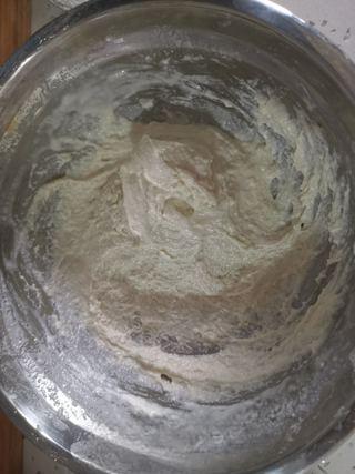 Easy Scallion Egg Pancakes step 1: Place the flour in a large bowl. Gradually add water while stirring until a thic