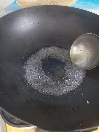 Sweet and Sour Spare Ribs step 5: In a clean wok, add a little oil and the rock sugar. Cook over medium-low heat u