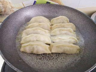 Beef Potstickers step 13: Cover and cook until the liquid is almost fully absorbed.