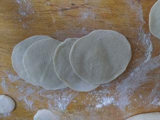 Beef Potstickers step 7: Roll the rested dough into a long log, divide into equal portions, and flatten e