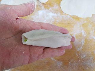 Beef Potstickers step 9: Place a spoonful of filling in the center of each wrapper and shape into potstic