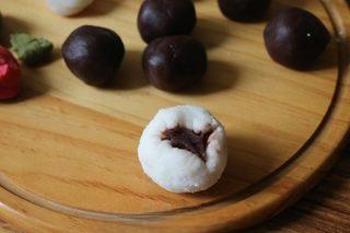 Snow Skin Mooncakes step 11: Lightly coat your hands with corn oil. Flatten a wrapper, place a red bean paste