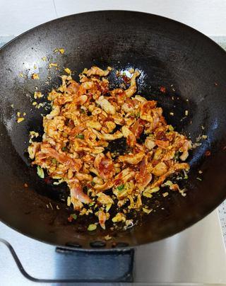 Fish-Fragrant Pork Strips step 12: Add the red bell pepper strips and stir-fry briefly.