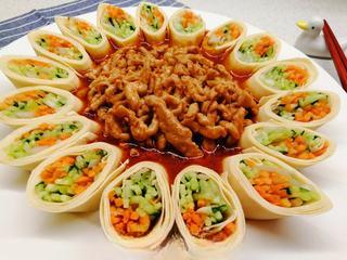 Pork Loin and Vegetable Rolls step 10: Place the sauced pork strips in the center of the arranged vegetable rolls.