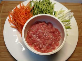 Pork Loin and Vegetable Rolls step 2: Julienne the cucumber and carrot. Slice the pork loin into thin strips.