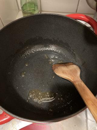 Braised Spare Ribs with Lotus Root and Mushrooms step 5: Heat oil in a heavy pot over medium heat. Add rock sugar and cook until melted a