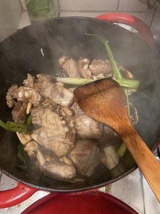 Braised Spare Ribs with Lotus Root and Mushrooms step 8: Add light soy sauce, dark soy sauce, oyster sauce, and scallions.