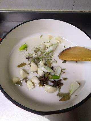 Braised Pork Trotters step 3: Heat oil in a pot. Add green onion, ginger, bay leaves, star anise, and fennel s
