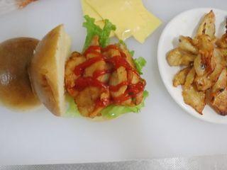 Louisiana Chicken Cheeseburger step 6: Slice the burger buns in half. Layer lettuce, cooked chicken, ketchup, and chees