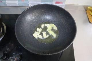 Stir-Fried Mushrooms with Cured Pork step 3: Heat cooking oil in a wok or skillet. Add the garlic and ginger and stir-fry unt