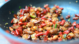 Spicy Fried Chicken with Peanuts step 10: Garnish with sesame seeds and chopped green onions, then serve immediately.