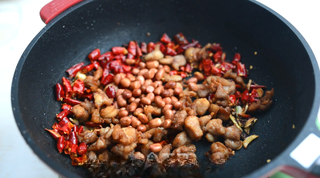 Spicy Fried Chicken with Peanuts step 9: Add the crispy chicken and roasted peanuts. Sprinkle in the sugar and stir-fry u