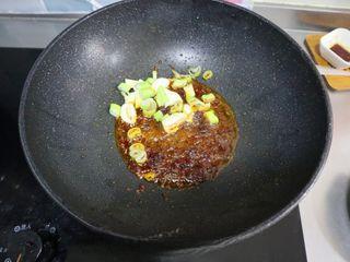 Kung Pao Chicken step 8: Leave a small amount of oil in the wok. Add Pixian doubanjiang and cook until th