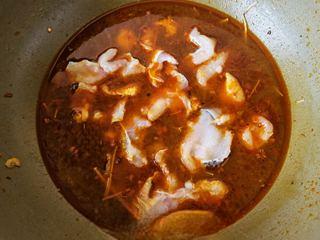 Spicy and Numbing Fish Hotpot step 17: Slide the fish slices into the simmering broth one piece at a time.
