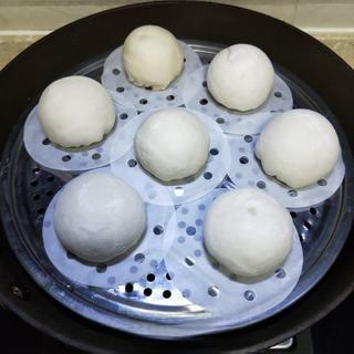 Milk Custard Steamed Buns step 26: Place the bun seam-side down.