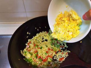 Golden Egg Fried Rice Recipe step 7: Return the scrambled eggs to the wok and toss everything together.