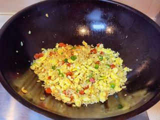 Golden Egg Fried Rice Recipe step 8: Season with salt and continue stir-frying until evenly combined.