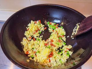 Golden Egg Fried Rice Recipe step 6: Add the egg-coated rice and stir-fry over medium-low heat until the grains becom