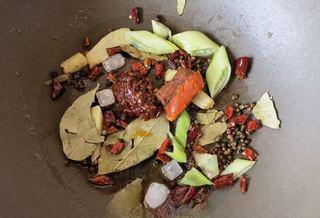 Mala Braised Pork Ribs with Potatoes and Onions step 6: Add Pixian doubanjiang and hot pot base.