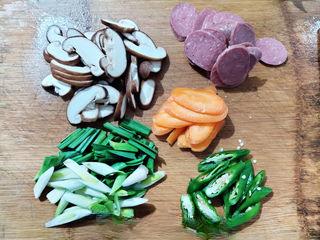 Stir-Fried Rice Cakes with Crispy Sausage and Vegetables step 1: Wash and prepare all vegetables. Slice the mushrooms, carrot, green bell peppers