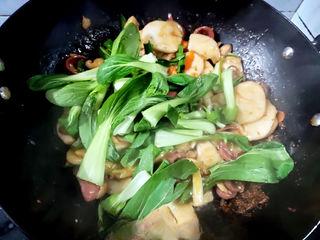Stir-Fried Rice Cakes with Crispy Sausage and Vegetables step 10: Add the green parts of the scallions and the baby bok choy. Stir-fry until the v