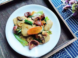 Stir-Fried Rice Cakes with Crispy Sausage and Vegetables step 11: Transfer to a serving plate and serve immediately.