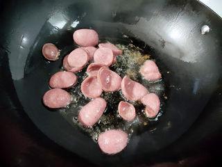 Stir-Fried Rice Cakes with Crispy Sausage and Vegetables step 4: Heat a wok over high heat with a little oil. Stir-fry the Chinese sausage until