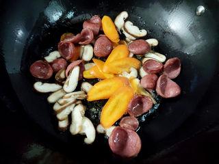 Stir-Fried Rice Cakes with Crispy Sausage and Vegetables step 5: Add the carrot and mushrooms. Stir-fry until softened.