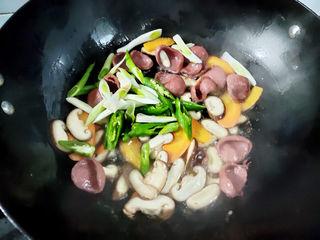 Stir-Fried Rice Cakes with Crispy Sausage and Vegetables step 6: Add the white parts of the scallions and the green bell peppers. Stir-fry until
