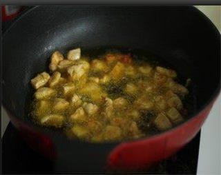 Cumin Chicken with Spicy Chili Crunch step 4: Heat oil in a wok or deep pan and fry the chicken cubes until golden brown and c