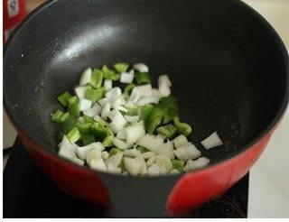 Cumin Chicken with Spicy Chili Crunch step 5: Leave a small amount of oil in the wok. Add the green bell peppers and onion, th