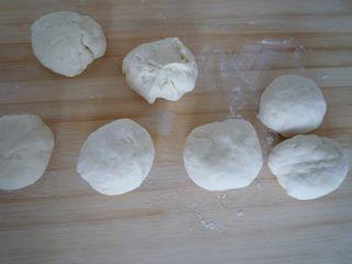 Steamed Milk Bread Rolls step 4: Transfer the dough to a work surface, knead to remove air bubbles, and divide it