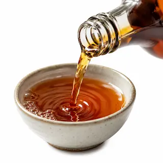 Amber Shaoxing cooking wine poured into a small bowl