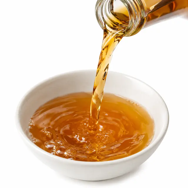 Amber cooking wine substitute poured into a small bowl